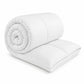 White hollowfibre duvet with soft microfibre cover, rolled to show loft — Luxe & Komfort