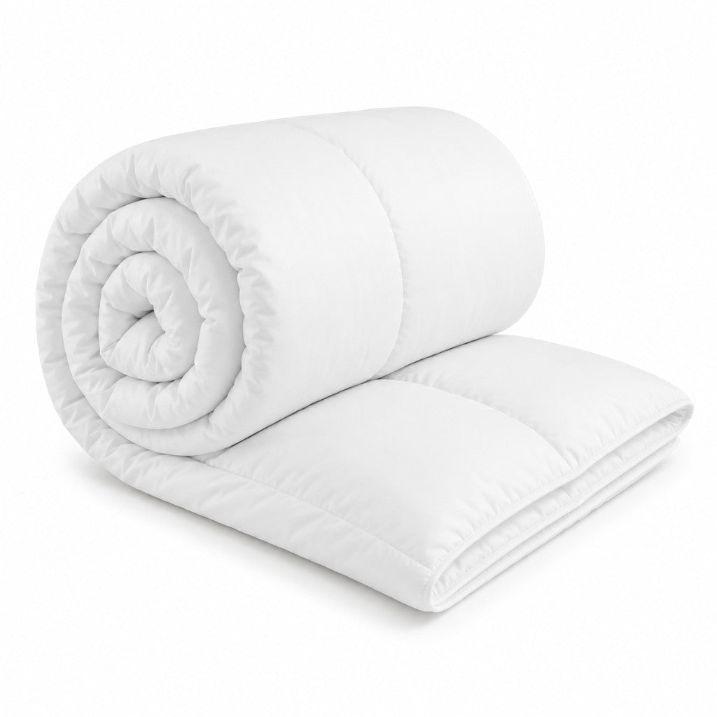 White hollowfibre duvet with soft microfibre cover, rolled to show loft — Luxe & Komfort